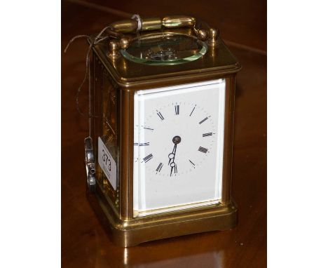 A brass striking carriage clock, circa 1890, carrying handle, enamel dial with Roman numerals, twin barrel movement striking 