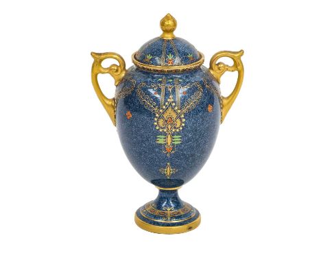 A Royal Worcester twin handled pedestal vase and cover with powder blue ground, edged in gilt and with jewelled enamel decora