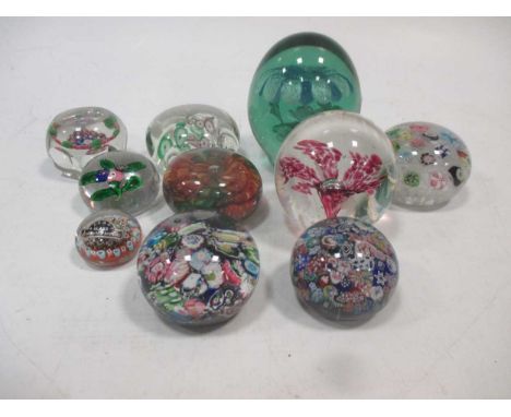 A collection of ten glass dump paper weights, some with cane work, including one bearing Vasart lable and another beleived to