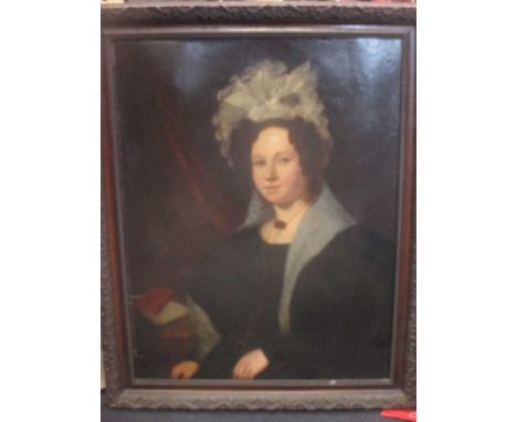 A 19th century portrait of a lady, oil on canvas, in a dark wooden carved frame, 89 x 69cm