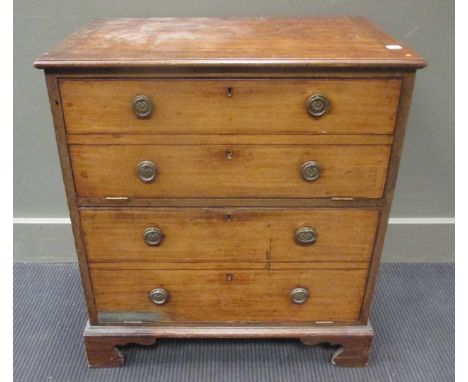 A small Georgian mahogany cabinet, adapted from a night commode, now with two fall fronts on bracket feet, 64cms