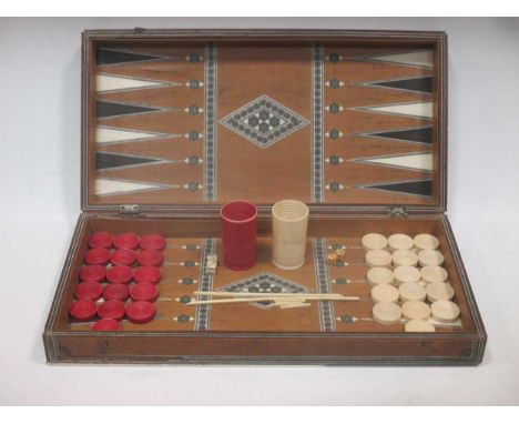 A 19th Anglo-Indian ivory and mosaic backgammon box with counters, shakers and dice 43x22 (losses)