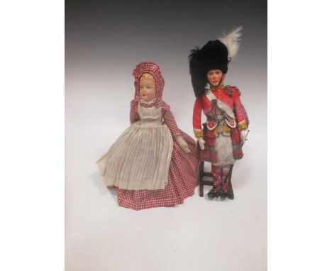 A painted felt head doll of HM The King, Highland uniform, by J.K. Farnell, boxed; together with a female doll with painted f