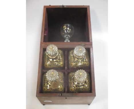 A 19th Century continental decanter box with rounded hinged top revealing four square section decanters with gilded shoulders