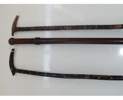 A bamboo walking stick, a hand painted walking stick and a swagger stick