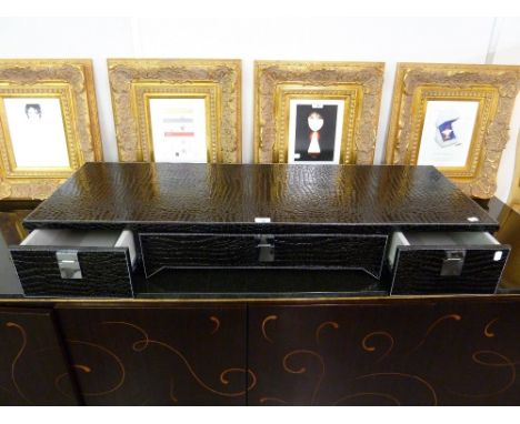 *A WALL MOUNTING DRESSING TABLE, CLAD IN BLACK SIMULATED CROCODILE SKIN WITH WHITE STITCHED EDGES, FITTED WITH A CENTRE DRAWE