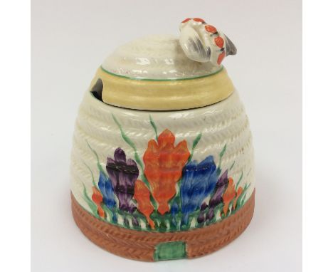 A 1930s Clarice Cliff Newport pottery 'Crocus' pattern honey pot and cover