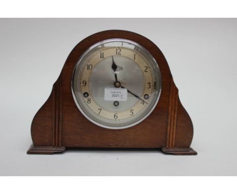 A Garrard late 1930s Westminster chime mantle clock; together with a late 19th/early 20th Century Banjo barometer, with carvi