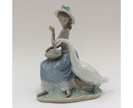 A Lladro figure, 'Goose trying to eat' designed by Vicente Martinez, numbered to base 5034, approx 25cm high