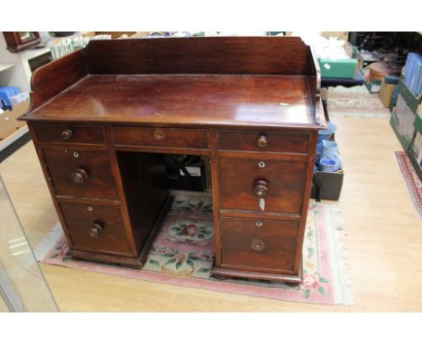 A 19th Century mahogany kneehole desk with splash back