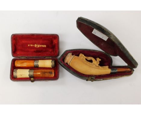 Butterscotch amber and meerschaum cheroot holders and carved pipe, in fitted cases 