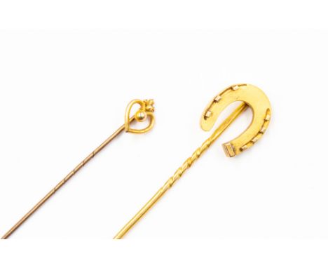 An 18ct gold stick pin, as a horseshoe, approx 3.8gms, a 9ct gold topped stick pin as a heart (2) 