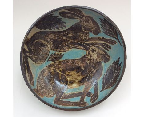 A late 20th Century abstract Studio pottery fruit bowl, hand painted with rabbits amongst falling leaves on an Earthenware bo