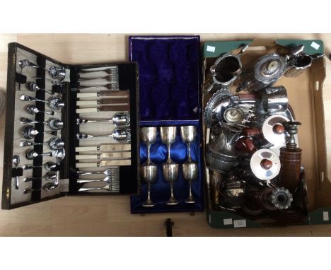 A box of assorted stainless steel, including Victorian tea service, spoons, sugar tongs, communion goblets, canteen, candlest