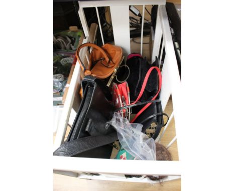 A wooden dolls cot with a doll with ceramic head and a collection of handbags 