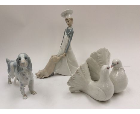 Lladro chef with a pig and pair of doves; together with Lladro style figure of a Spaniel (3) 