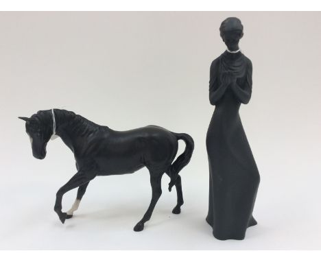 A black bisque Beswick horse together with a Royal Doulton black bisque figurine, 'Tenderness' (2)