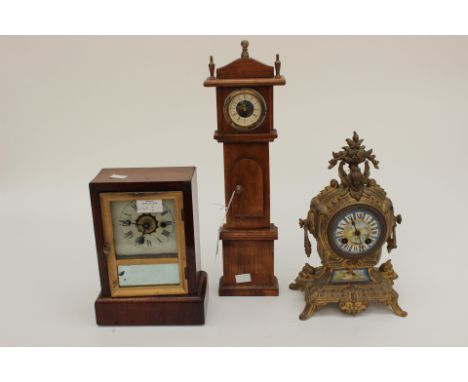 A collection of clocks including a French gilt metal ornamental mantel clock, the ceramic dial painted with naive scene and R