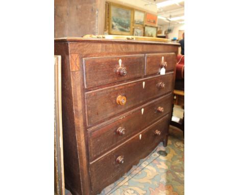 A George III oak and mahogany cross-banded chest of drawers, comprising two short over three long graduated drawers, bracket 