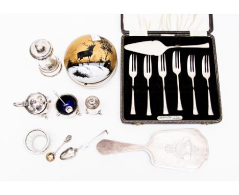 An EPNS cake set, white metal vanity mirror, EPNS pepper mill, silver mounted glass salt, three piece EPNS condiment set, two