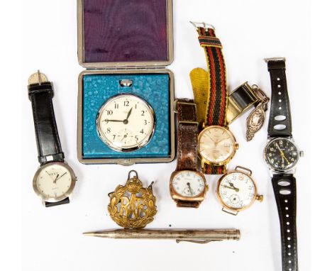 A collection of various wristwatches, including two with yellow metal cases, a jewellers loupe, a desk clock, propelling penc