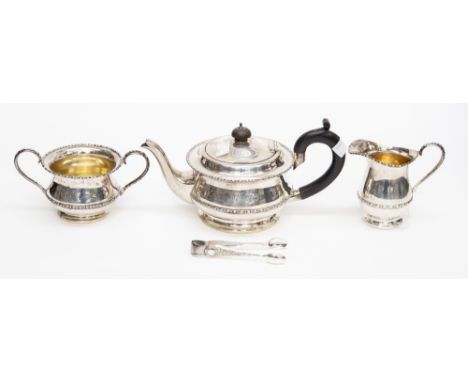 A George V silver three piece tea service, including teapot, sugar bowl and milk jug, plain bodies with egg-and-dart borders,