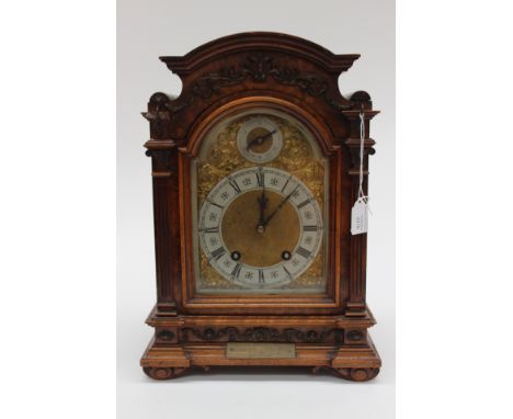 German walnut cased two train presentation mantle clock with brass and silvered dial,  with pendulum and key