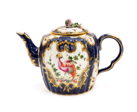 A Continental Worcester style blue  lobed barrel shaped teapot and cover, decorated with fan shaped reserves with exotic bird