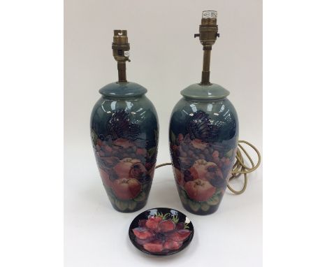 A pair of Moorcroft finches & berries pattern table lamps, one repaired, and a trinket dish (3)
