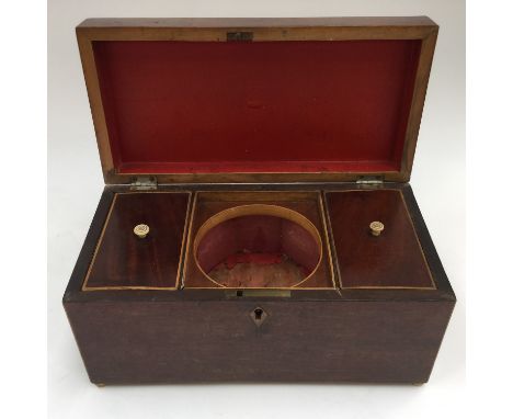 An early 19th Century mahogany tea caddy, complete with a fitted interior, having two lidded compartments 