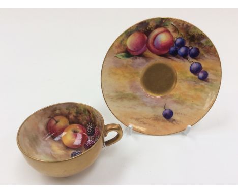 A Royal Worcester miniature teacup and saucer, painted with apples and berries, signed E. Townsend. Puce backstamp.