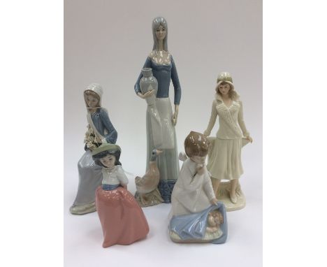 A Lladro figurine of a lady with lillies; together with another of an angel sleeping child, a Nao figure of a girl and two ot