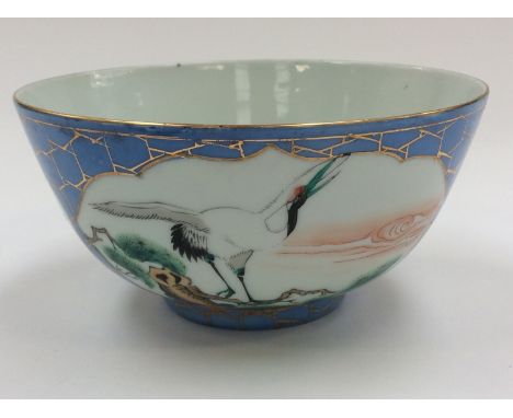 A believed 19th Century Oriental ceramic bowl having a blue and gilt ground with white cartouche panels depicting cranes with