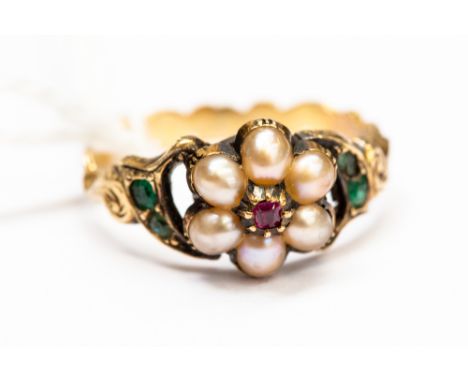 A Victorian yellow metal pearl, emerald and ruby set ring, scroll and engraved shank, size J 1/2, approx 2.6gms gross