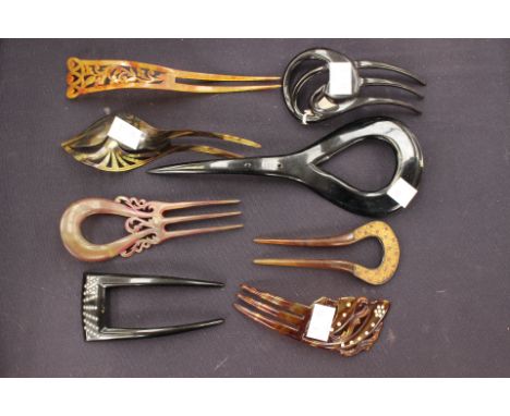 A dark and light effect high head piece with a four sprung comb, an asymmetrical shape plus six smaller amber and tortoiseshe