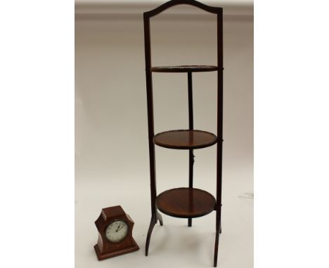 An early 20th Century French mantle clock, mahogany cased, eight day, together with a three-tier cake stand (2)