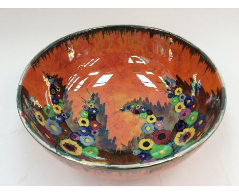 A Carltonware bowl, floral pattern on orange ground, gilt rim 