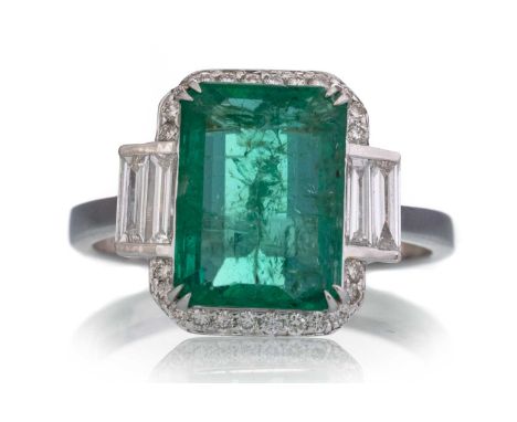 CERTIFICATED EMERALD AND DIAMOND RING, set with an octagonal step cut emerald of approximately 3.57 carats, flanked by diamon