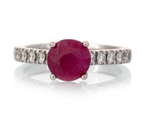 RUBY AND DIAMOND RING, set with a round ruby, on diamond set shoulders, in eighteen carat white gold, size JQty: 3.2g