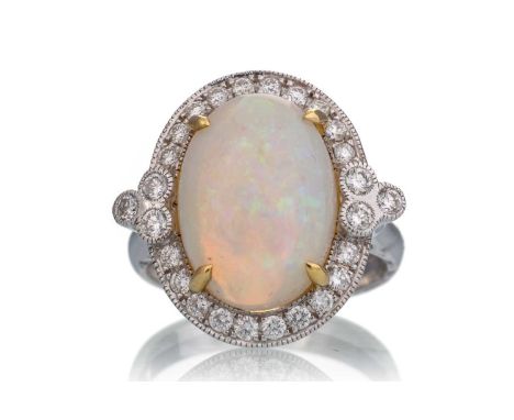 OPAL AND DIAMOND RING, set with a central cabochon opal of approximately 5.22 carats, within a halo of diamonds totalling app