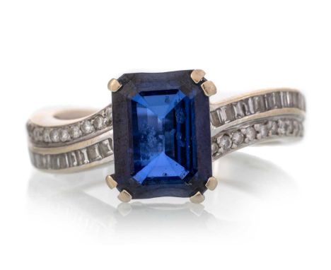 SAPPHIRE AND DIAMOND RING, set with a central step cut sapphire, on diamond shoulders, marked 750, size KQty: 4.1g