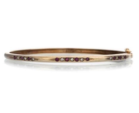 RUBY AND DIAMOND BANGLE, set with small rubies and diamonds, indistinctly markedQty: 12.2g