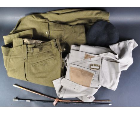 A collection of assorted 20th Century British Army uniform items, comprising a post-war size 30 dress jacket with lapel badge