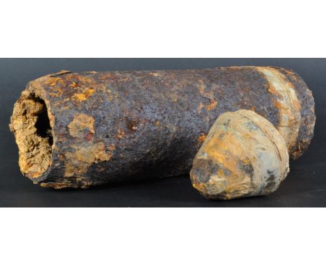 A WWI First World War large artillery shell relic (inert). Heavy iron shell body, with a detached fuse section. Relic conditi