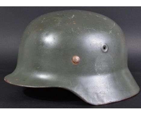 A WWII Second World War Third Reich Nazi German scarce M40/52 stahlhelm steel combat helmet. Retains an original nine-tongue 