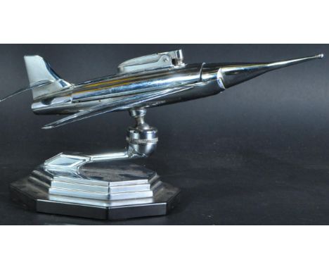 A 1950s Art Deco style chrome desktop cigarette lighter in the form of a fighter jet. Removable cigarette lighter to fuselage