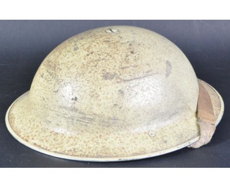 An original WWII Second World War British Army steel Brodie helmet, likely an original BEF helmet, later painted in Desert / 