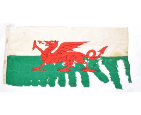 A WWI First World War interest battle damaged Welsh flag / Flag Of Wales. Typical form in white and green, with central red d