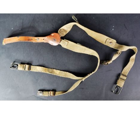 A WWII Second World War piece of German Third Reich Nazi Army uniform webbing. Canvas straps, with leather section and variou