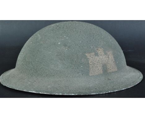 A WWII Second World War British Army steel combat Brodie helmet. Dated 1940 to liner, with green textured finish. Complete wi